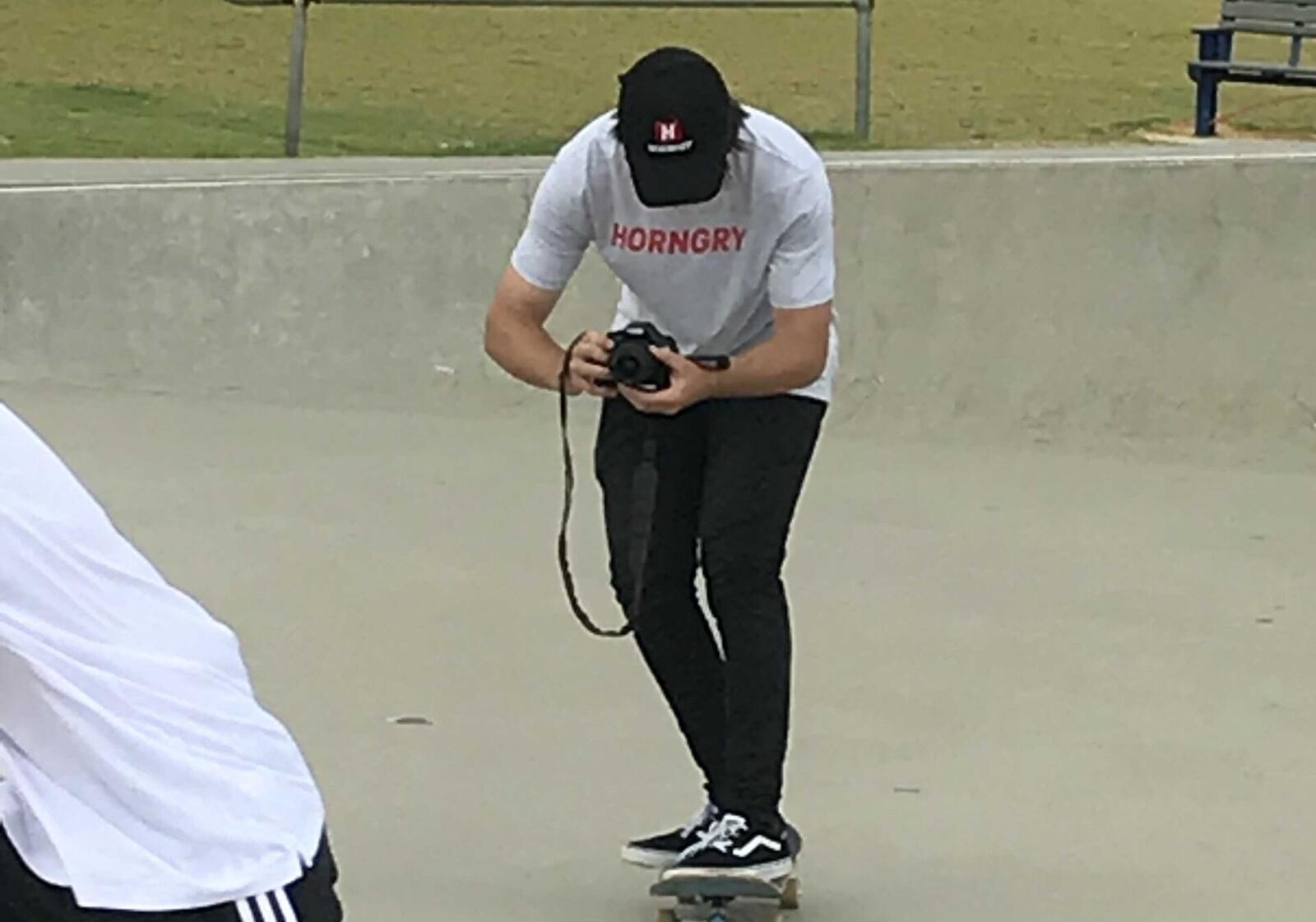 Skate park photographer reviewing a shot
